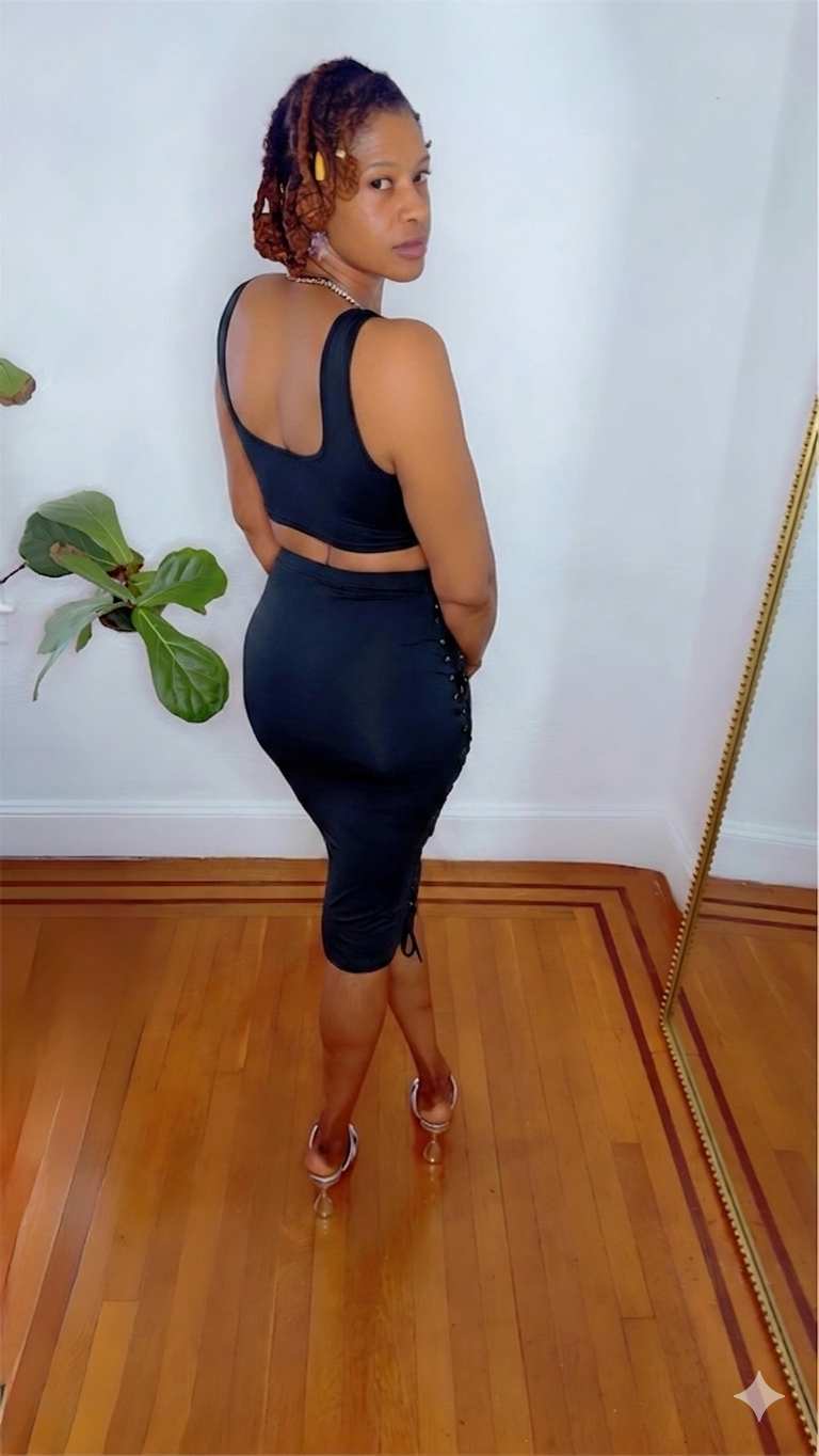 Black Swan Lace Dress in black — black-swan-lace-dress-side-viewbshowing lace-up side detailing and body-hugging midi length from MonologueClosets