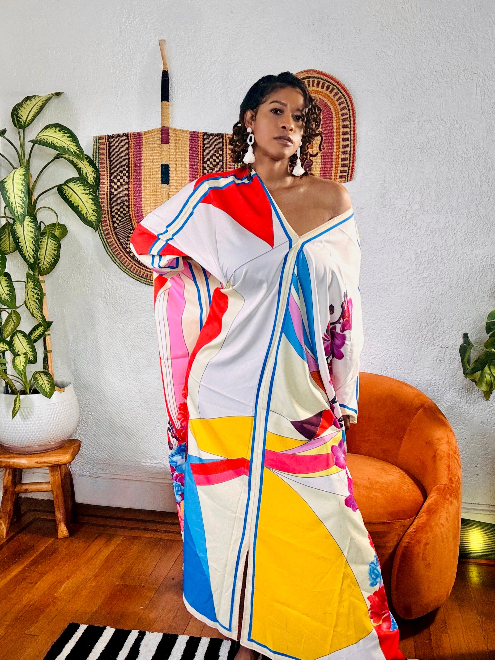 Woman wearing the Bloom Kaftan in vibrant multicolor print with batwing sleeves.