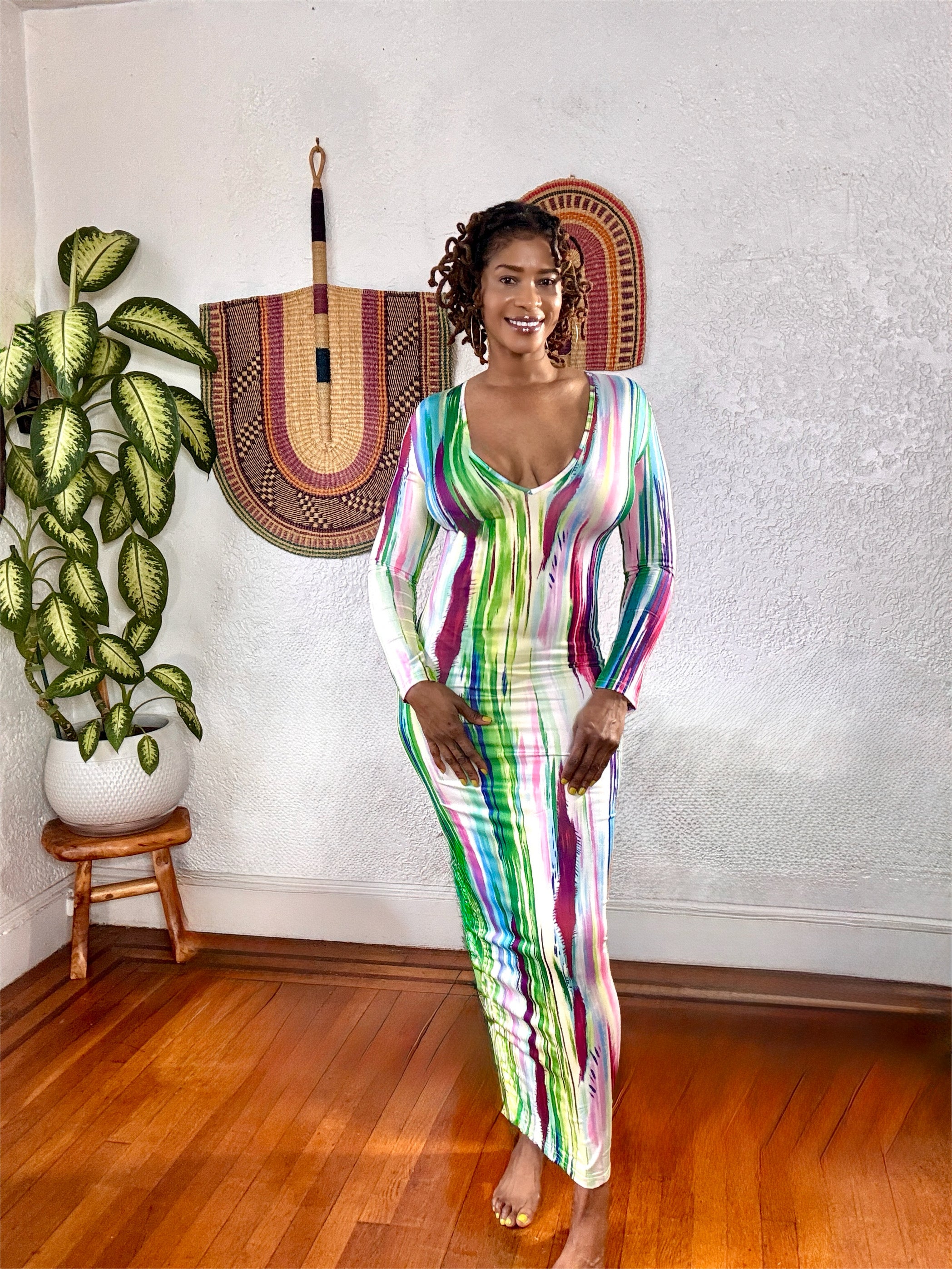 Side view of the long-sleeve maxi dress showing its curve-hugging stretch fit.