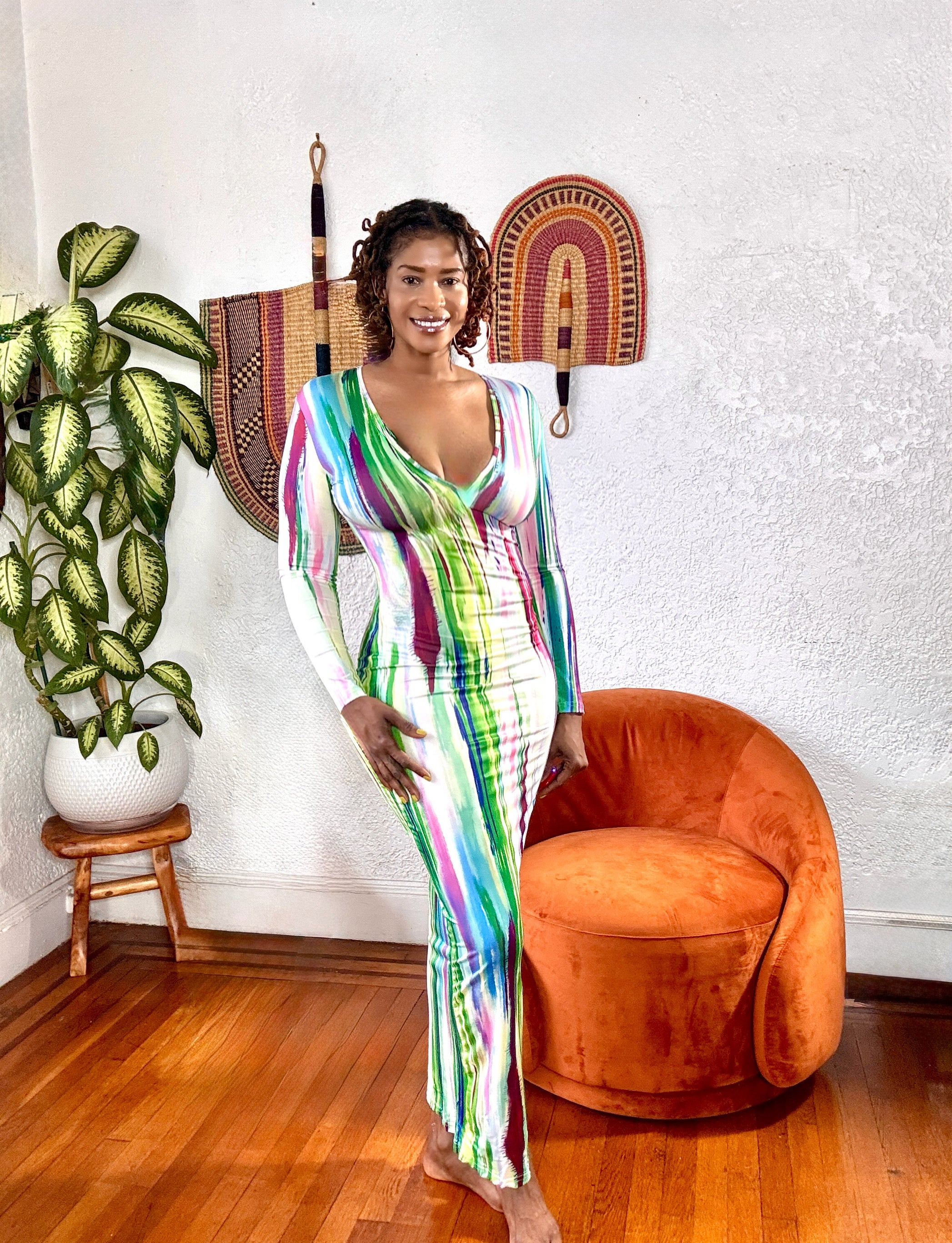 Side view of the long-sleeve maxi dress showing its curve-hugging stretch fit.