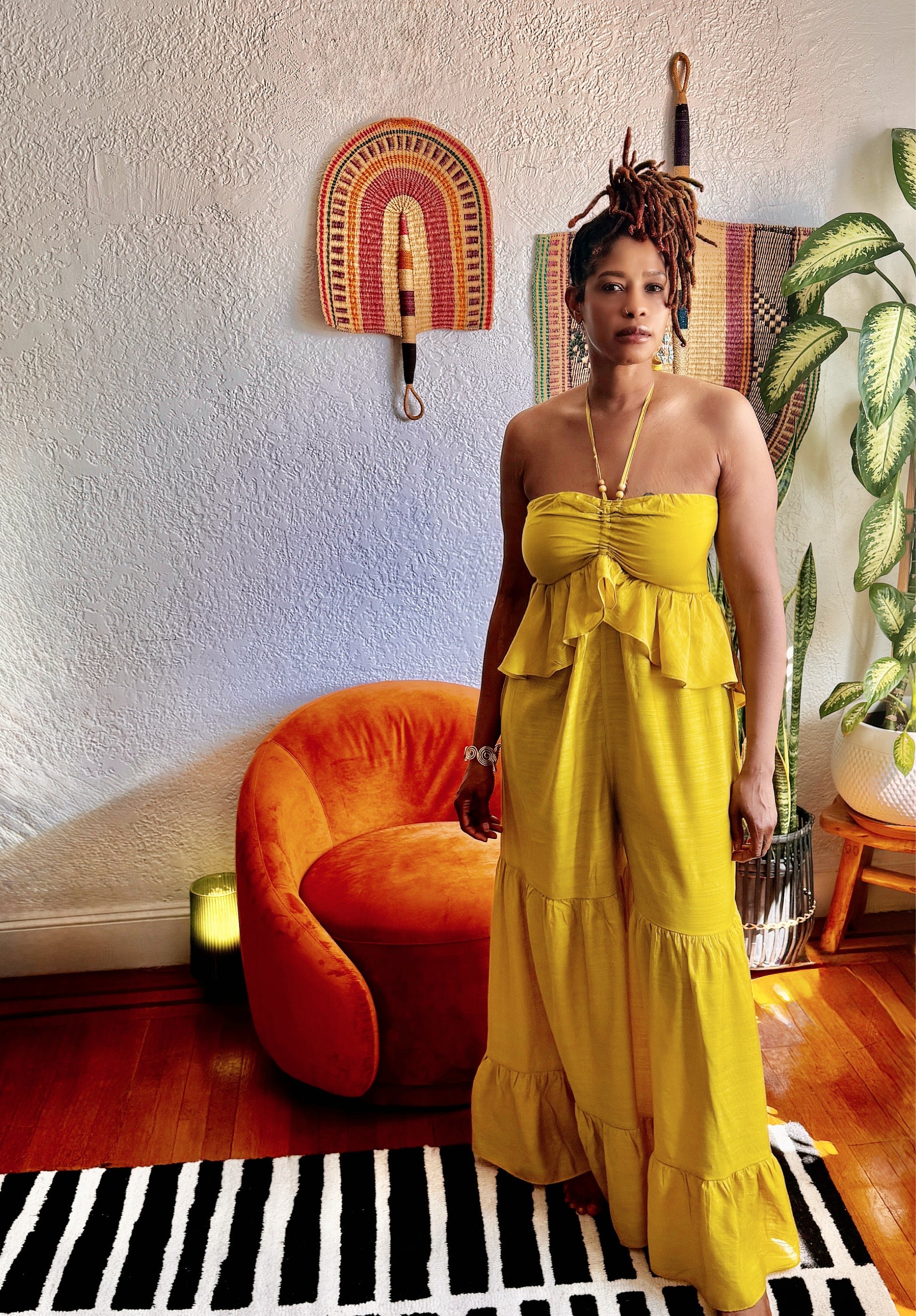 Side profile of Butterfly Ruffle Romper showing flowy wide-leg silhouette and layered ruffles.”