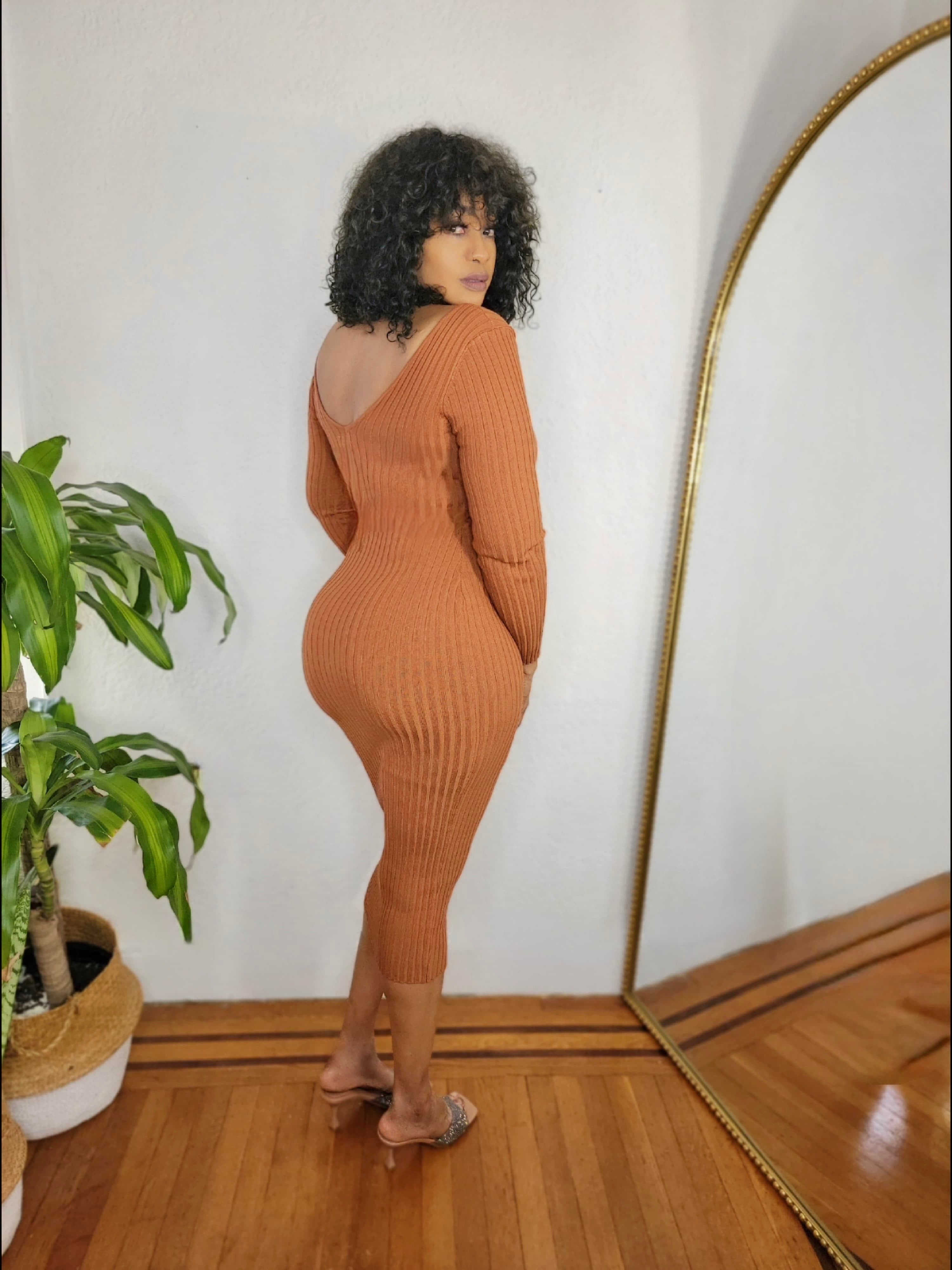 Side view of ribbed long-sleeve bodycon knit dress.
