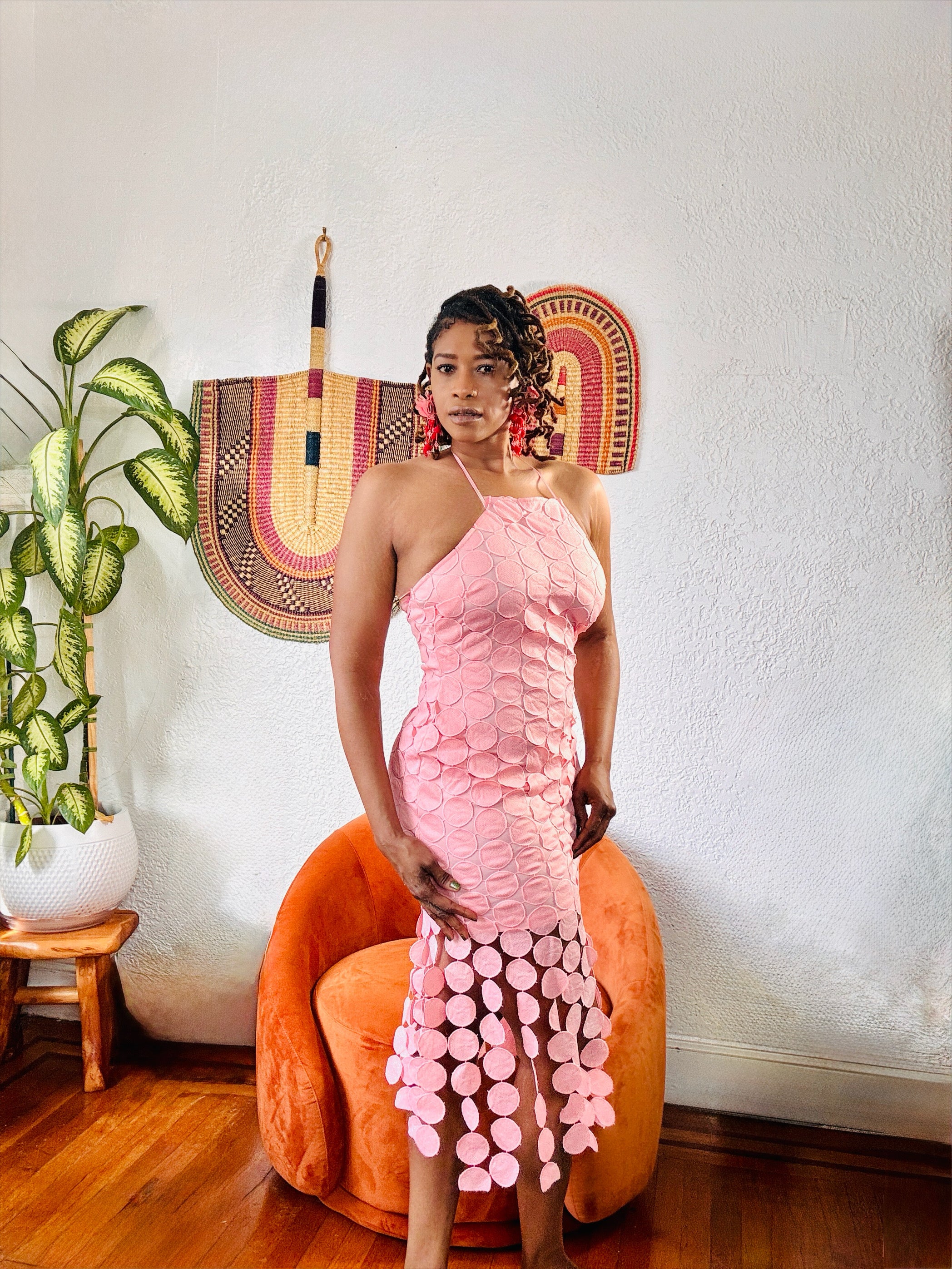 Model wearing the Circled Then Ends Tiered Midi Dress in blush, showing halter neckline and circle hem detailing.”