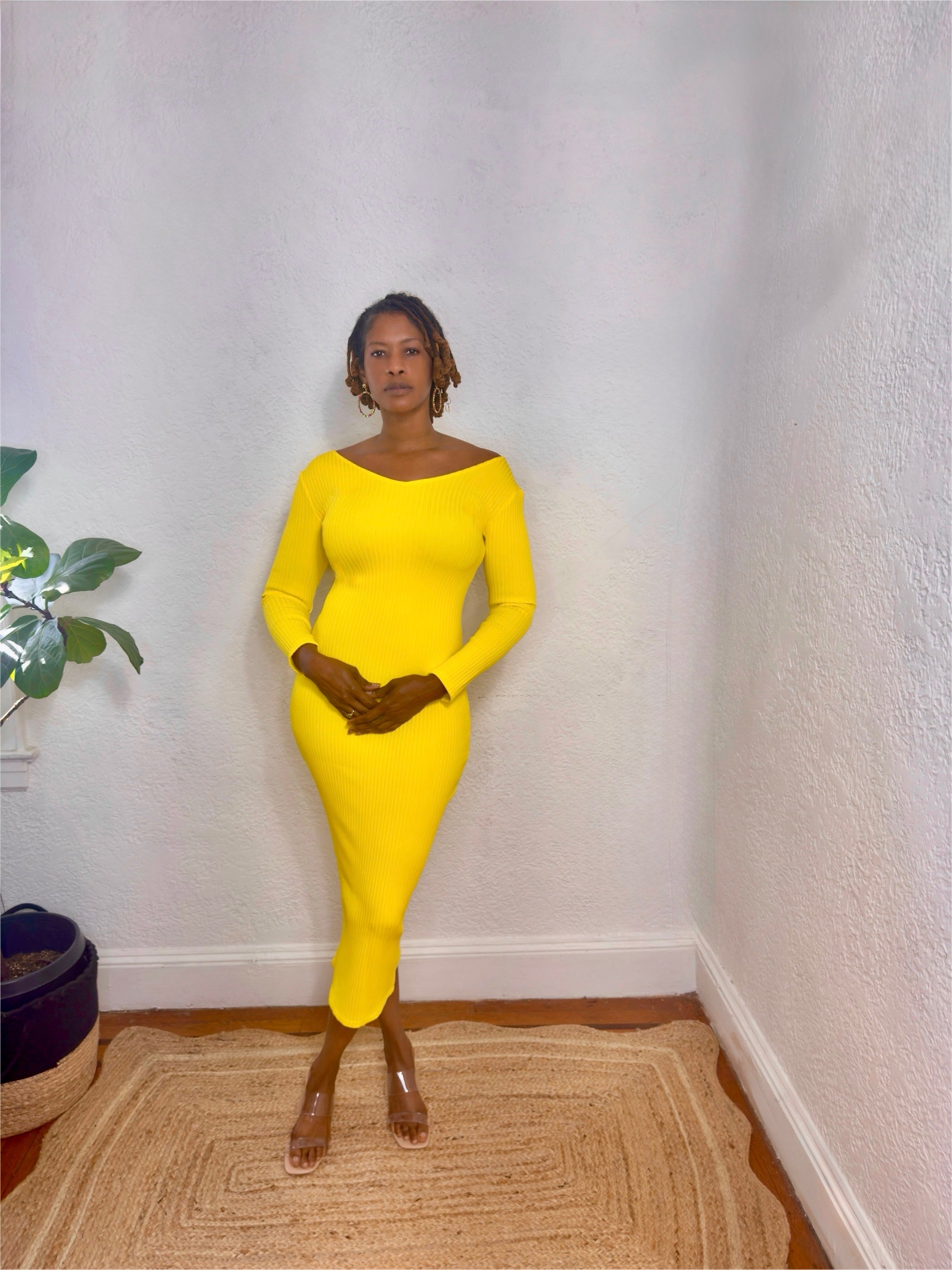 Side angle showing the body-hugging ribbed texture and off-shoulder neckline.