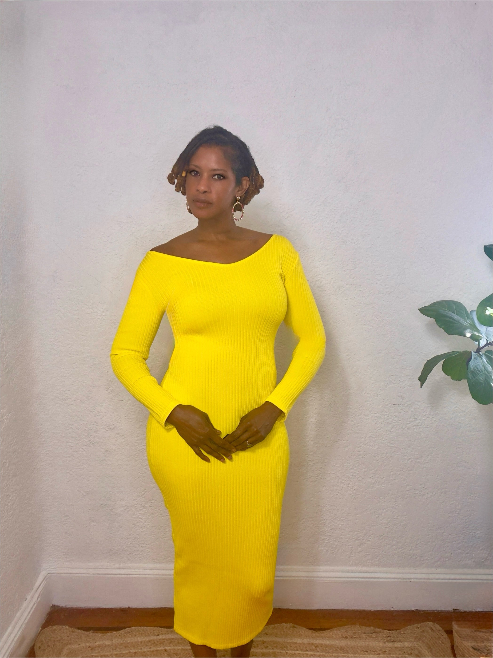 Rear view showcasing the smooth silhouette and bright color tone of the dress.