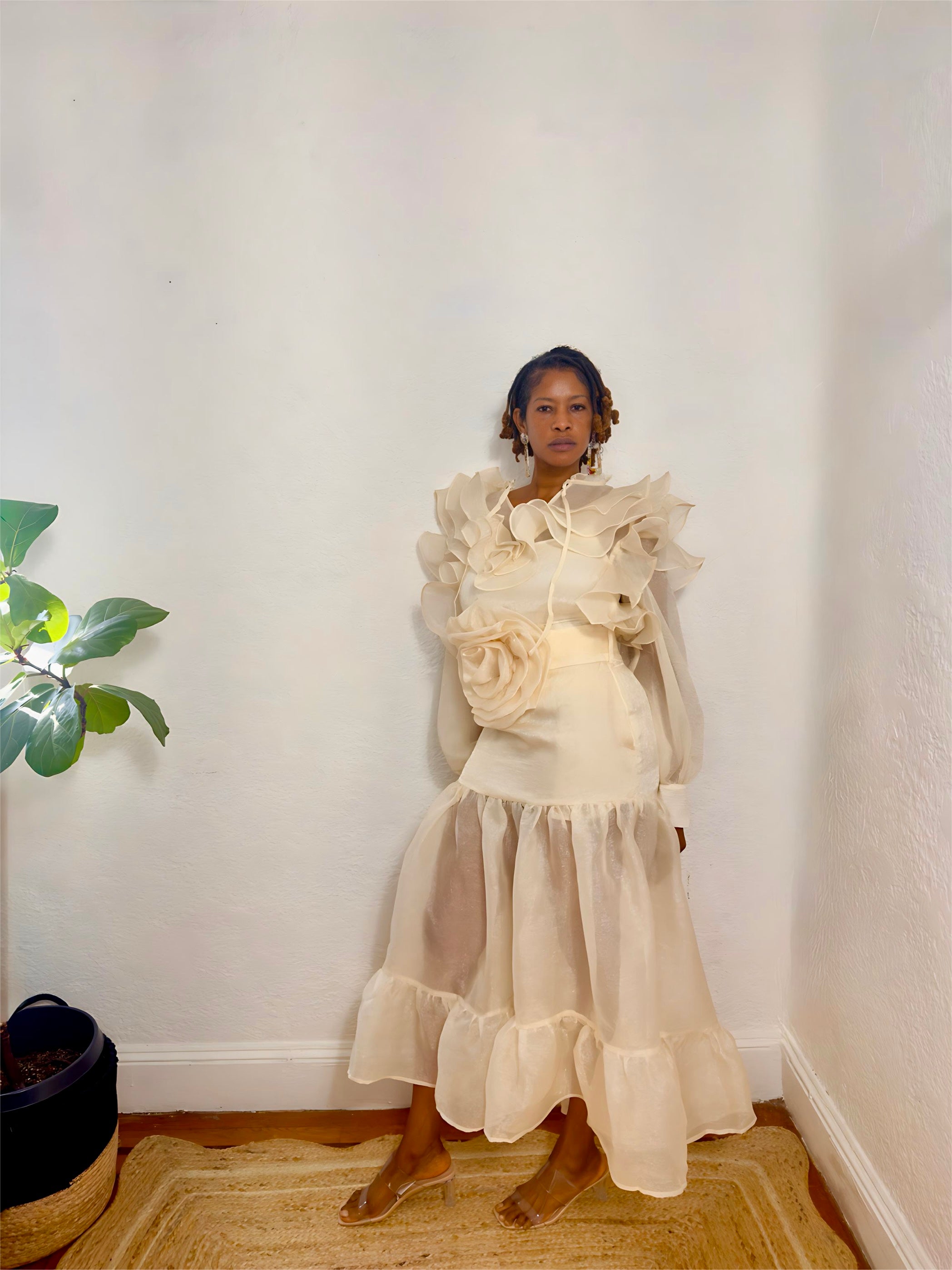 Front view of two-piece ruffle outfit featuring puff sleeves and 3D flower belt.