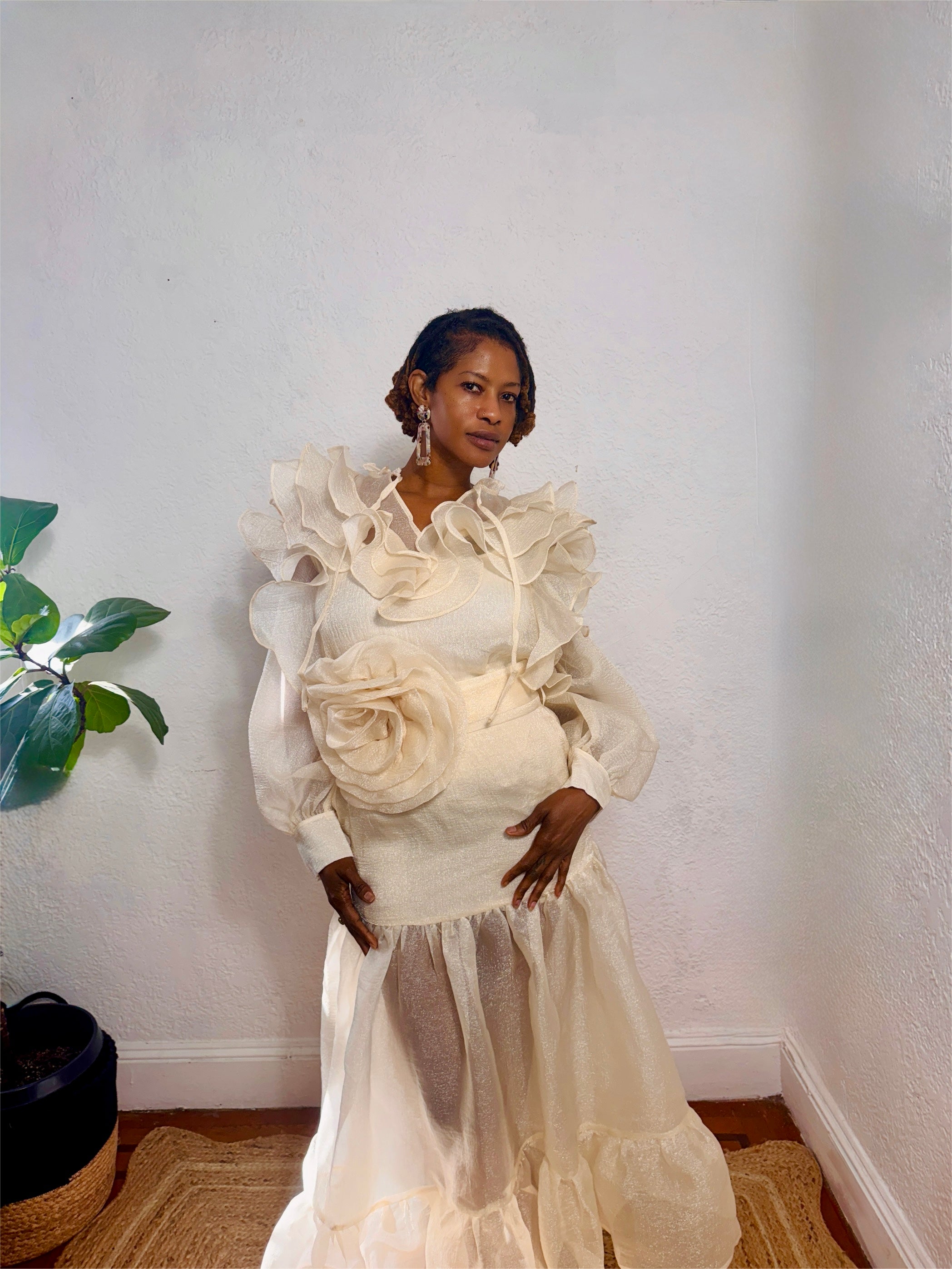 Front view of two-piece ruffle outfit featuring puff sleeves and 3D flower belt.