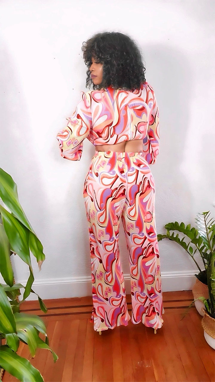 Back view highlighting the flowy pants and colorful abstract pattern.