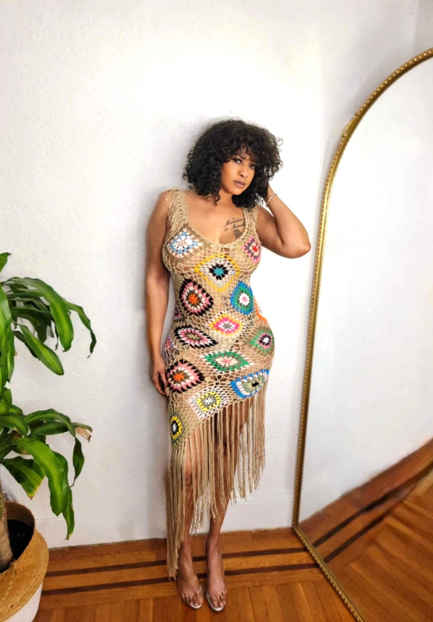 
Model wearing the Island Goddess Crochet Dress from MonologueClosets — handmade multicolor crochet dress with a flattering bodycon fit and fringe hemline.
