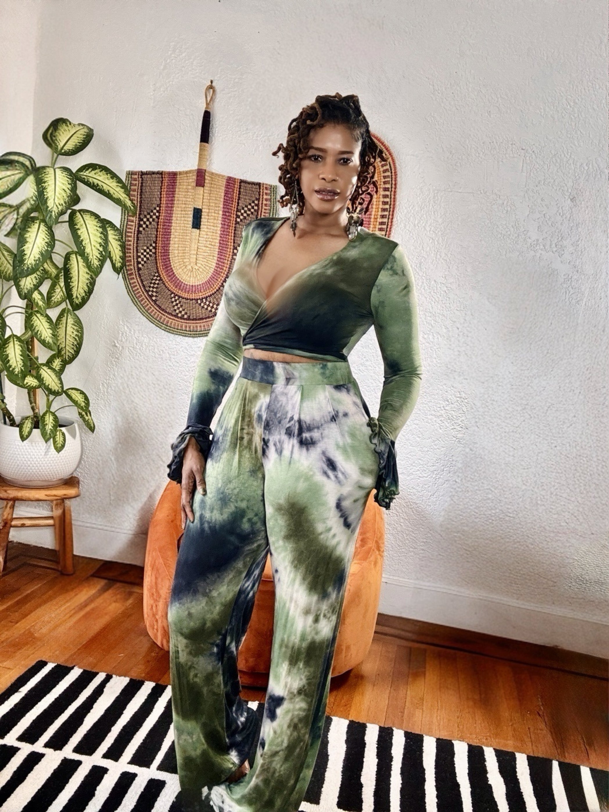 Model wearing the Jungle Aura 2-Piece Set in forest green and indigo tie-dye with wide-leg pants and wrap crop top.