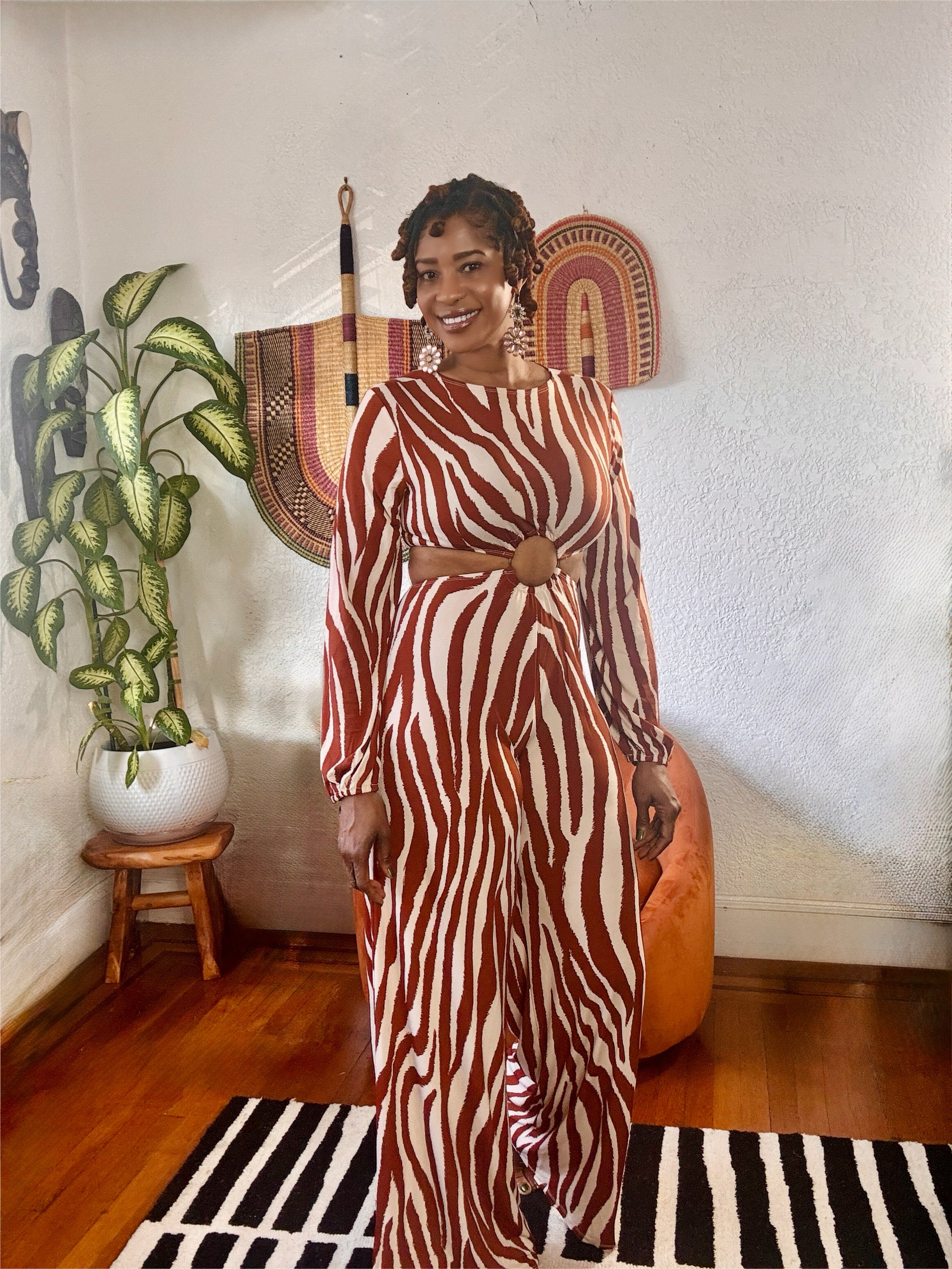Full-body shot of model in the MAKE ME WILD Zebra Print Jumpsuit styled with heels — chic, confident, and fashion-forward look.