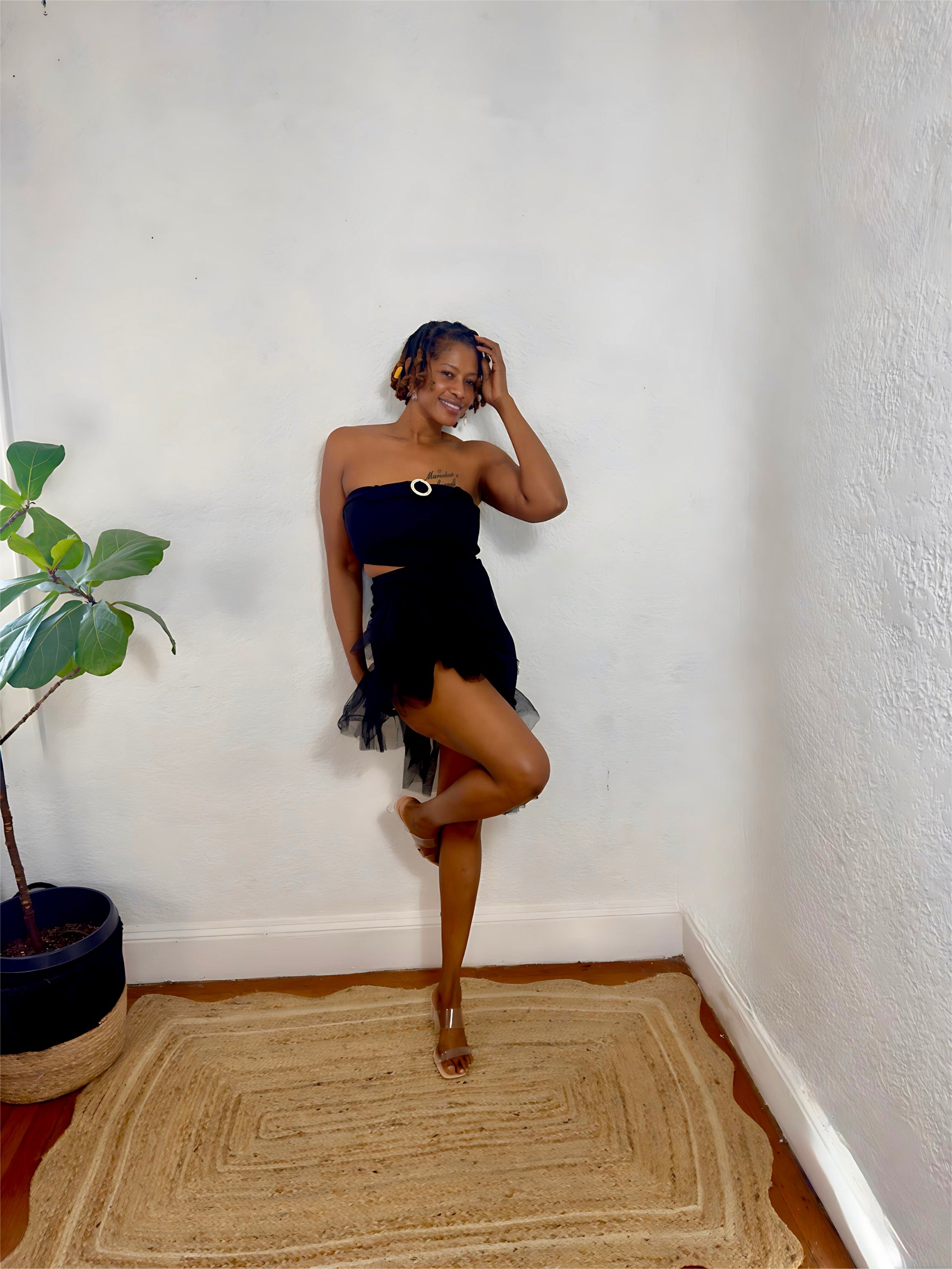 Model posing in the Midnight Flirt Set under soft lighting, showing the chic black tone and playful hem detail.