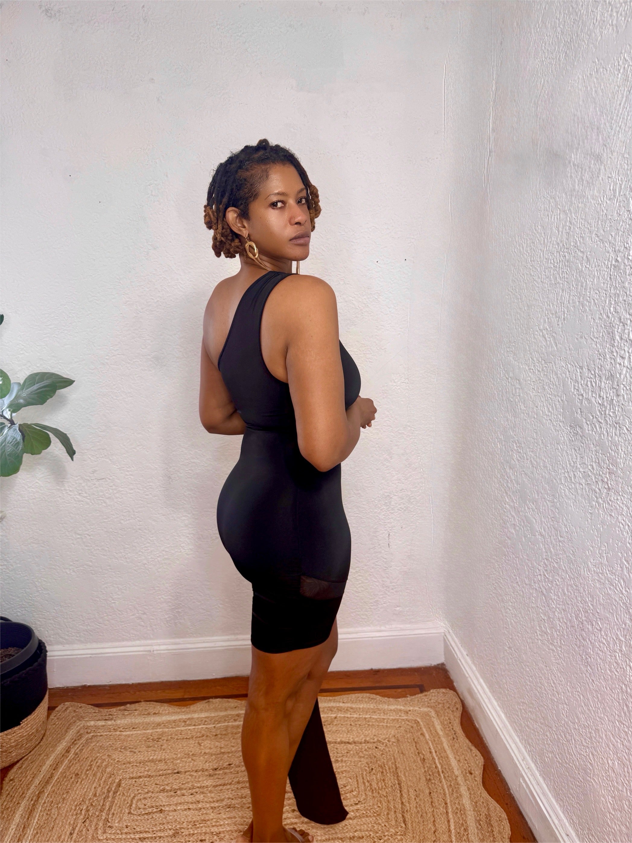 Full-body image of the Nightfall One-Shoulder Dress styled with gold heels for a chic night-out look.