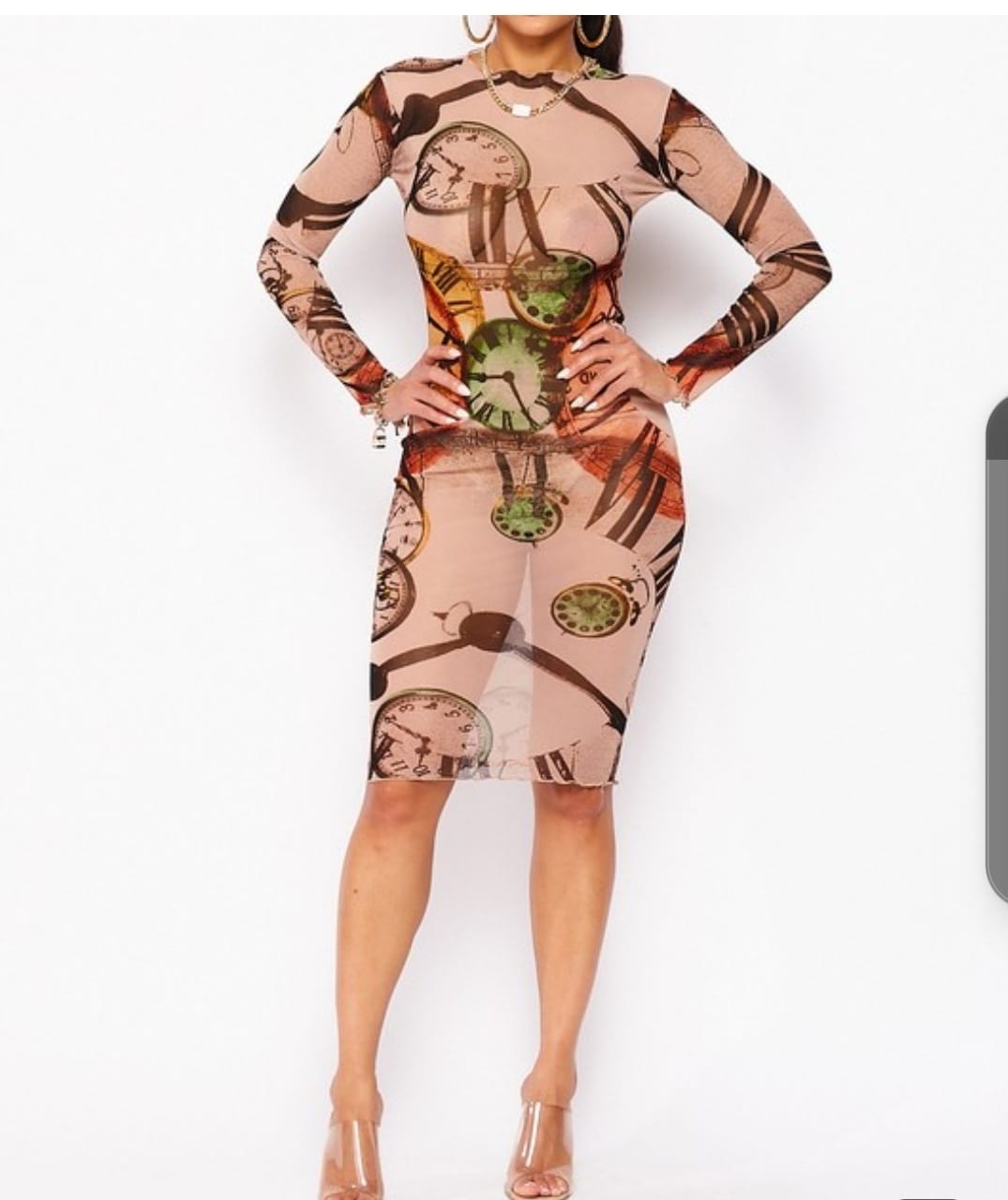 Woman wearing the Right on Time Dress from MonologueClosets — long-sleeve bodycon dress with a bold clock-print design and tailored fit, styled with clear heel