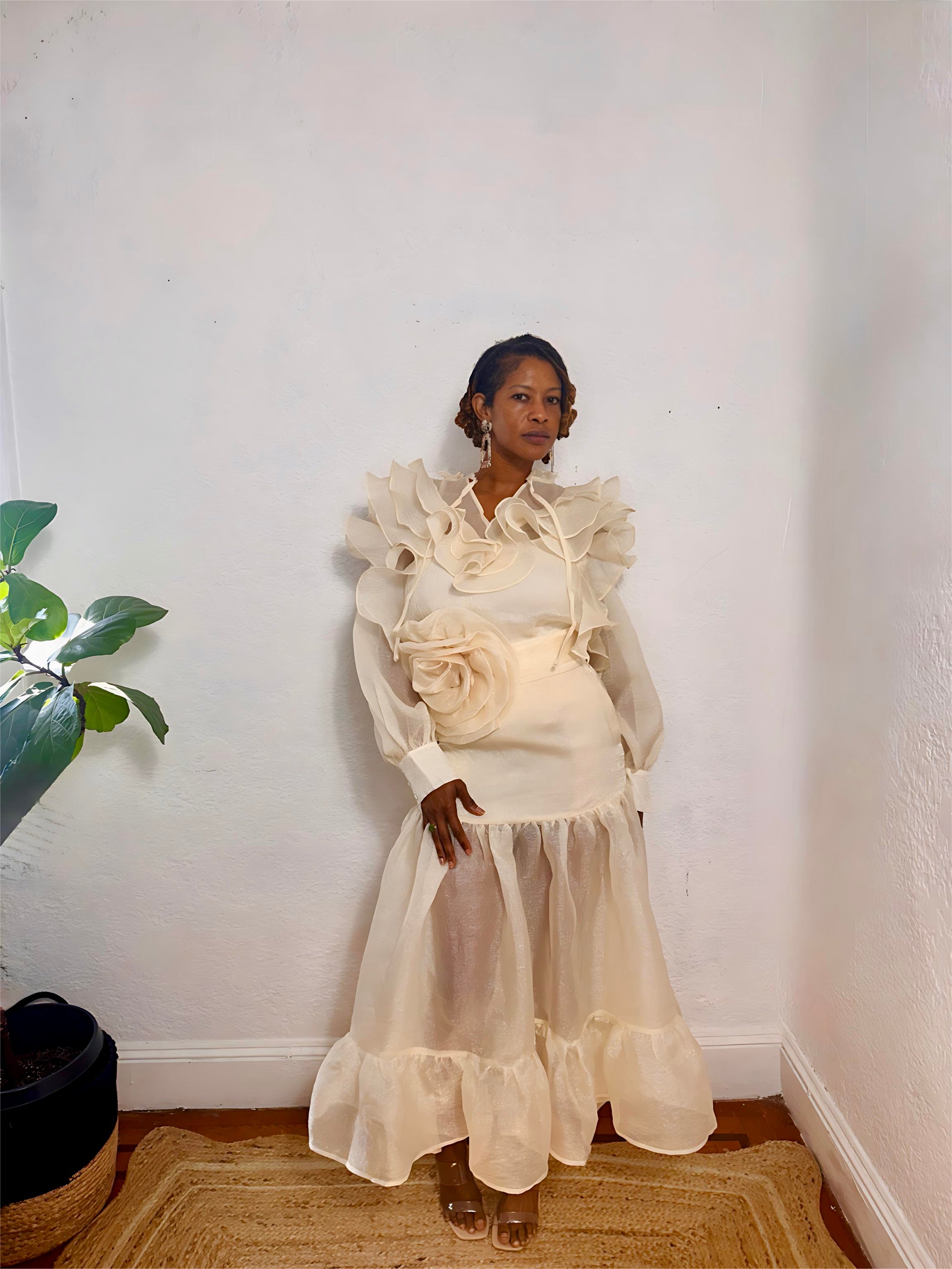 Woman wearing the Ethereal Bloom Set in French Vanilla with ruffled sheer top and midi skirt.