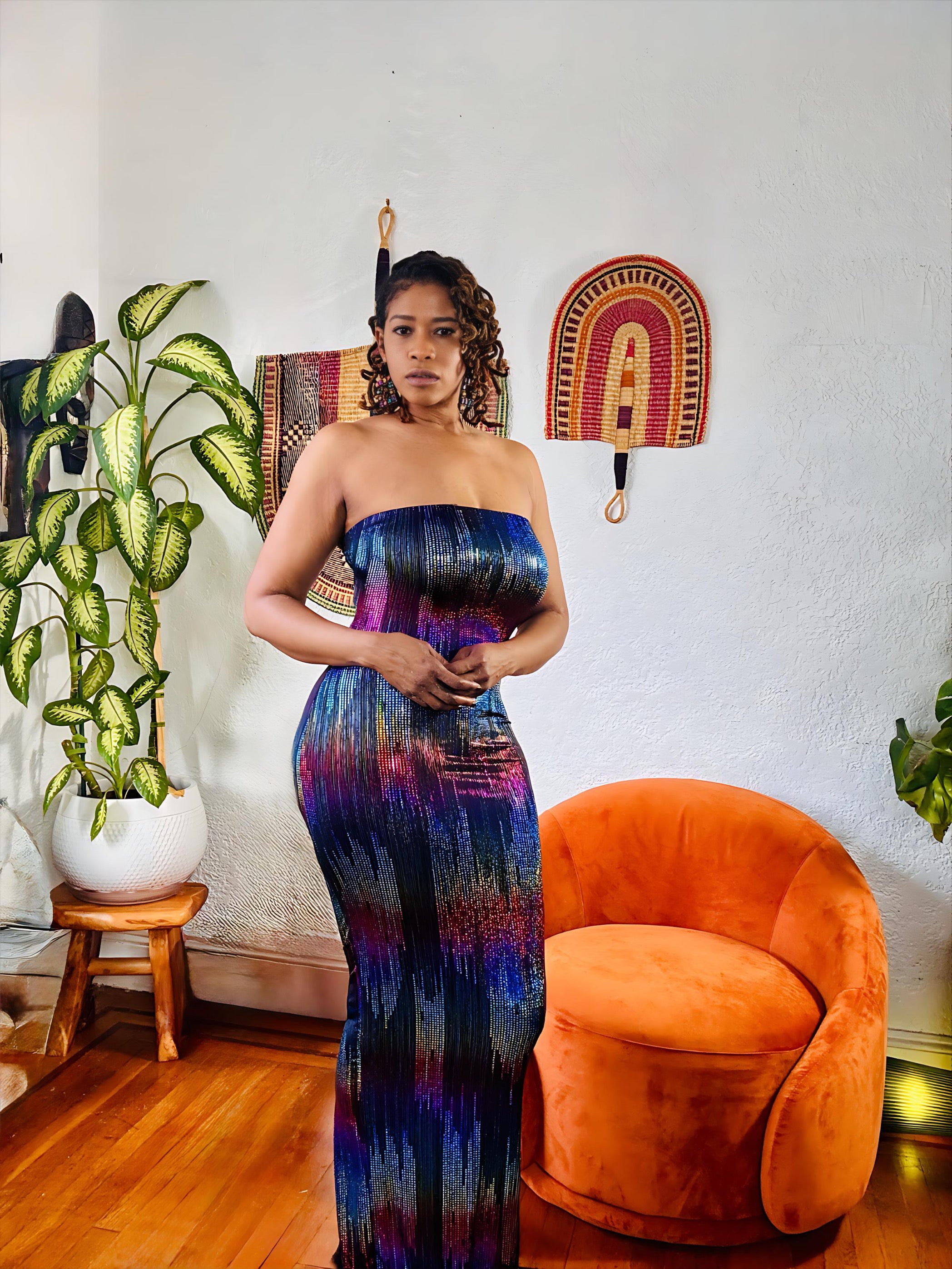 Full-body shot of model wearing the Scandal Shimmer Dress — a strapless, curve-hugging design that glimmers under the light for a bold night-out look.