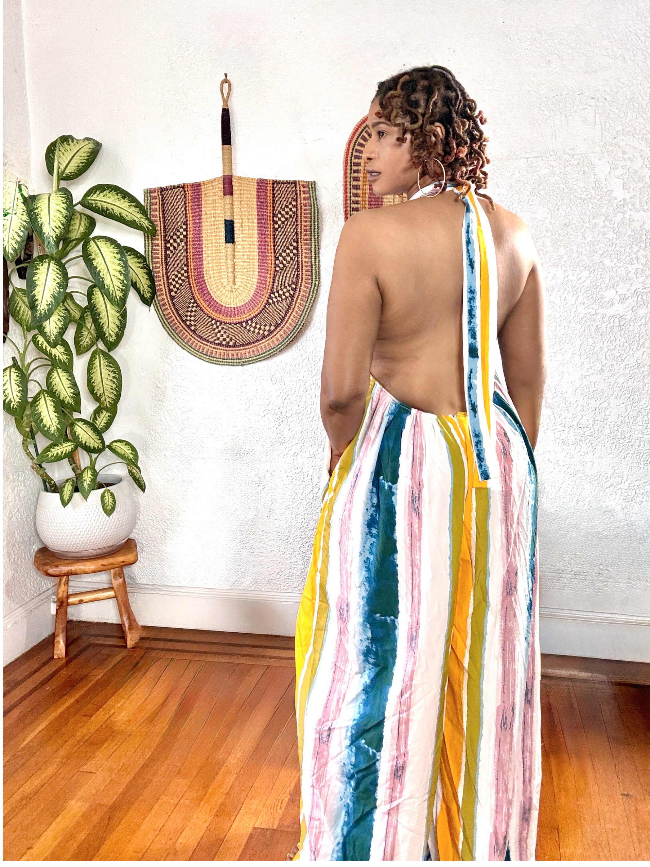 Back view of the Sunset Drip Halter Jumpsuit featuring halter tie closure and soft, flowy movement.