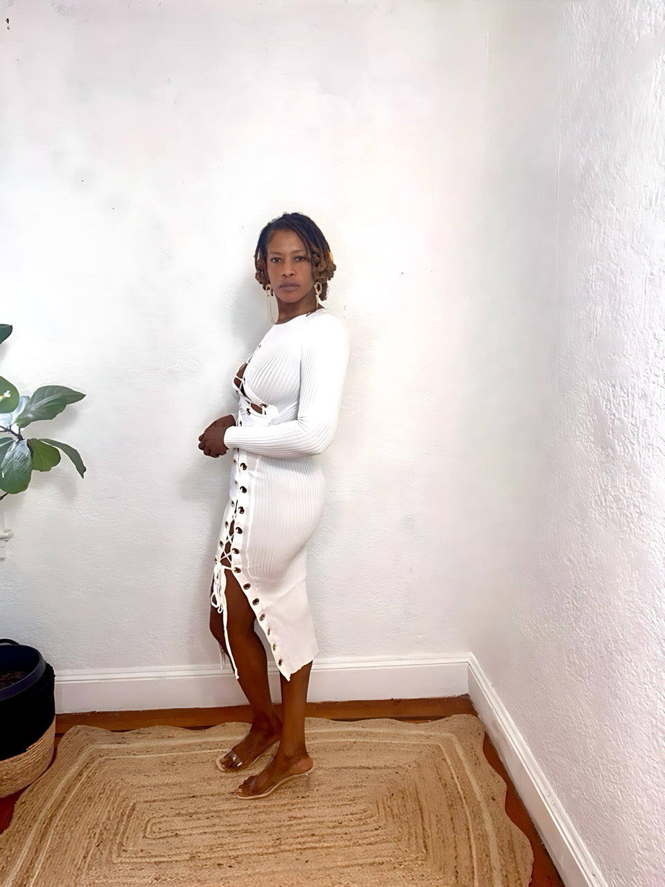 Side view lace-up design and gold eyelet detailing on the Twist & Lace Midi Dress.”