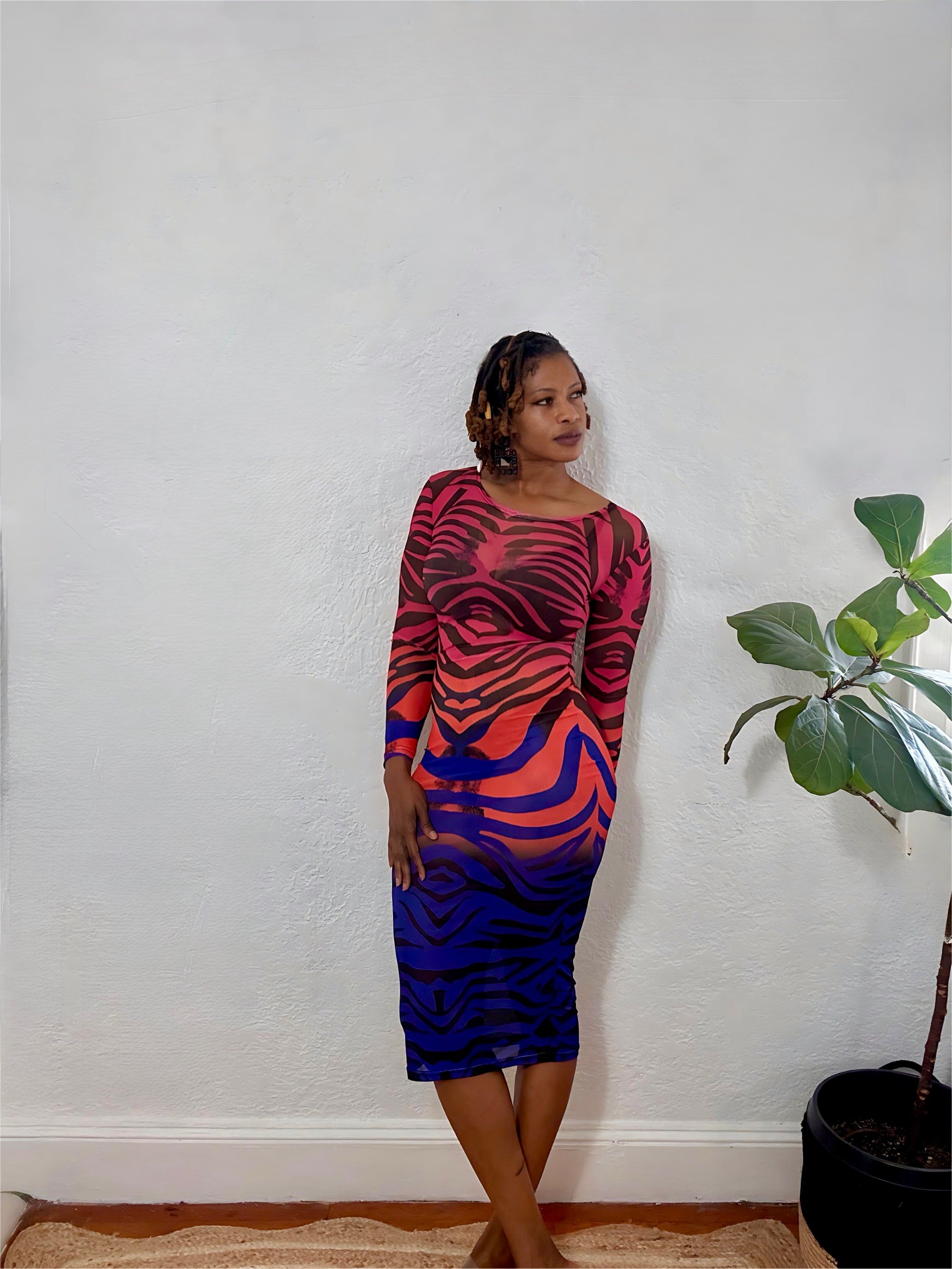 Side angle showing the body-hugging silhouette and illusion mesh pattern of the Vivid Illusion Dress.