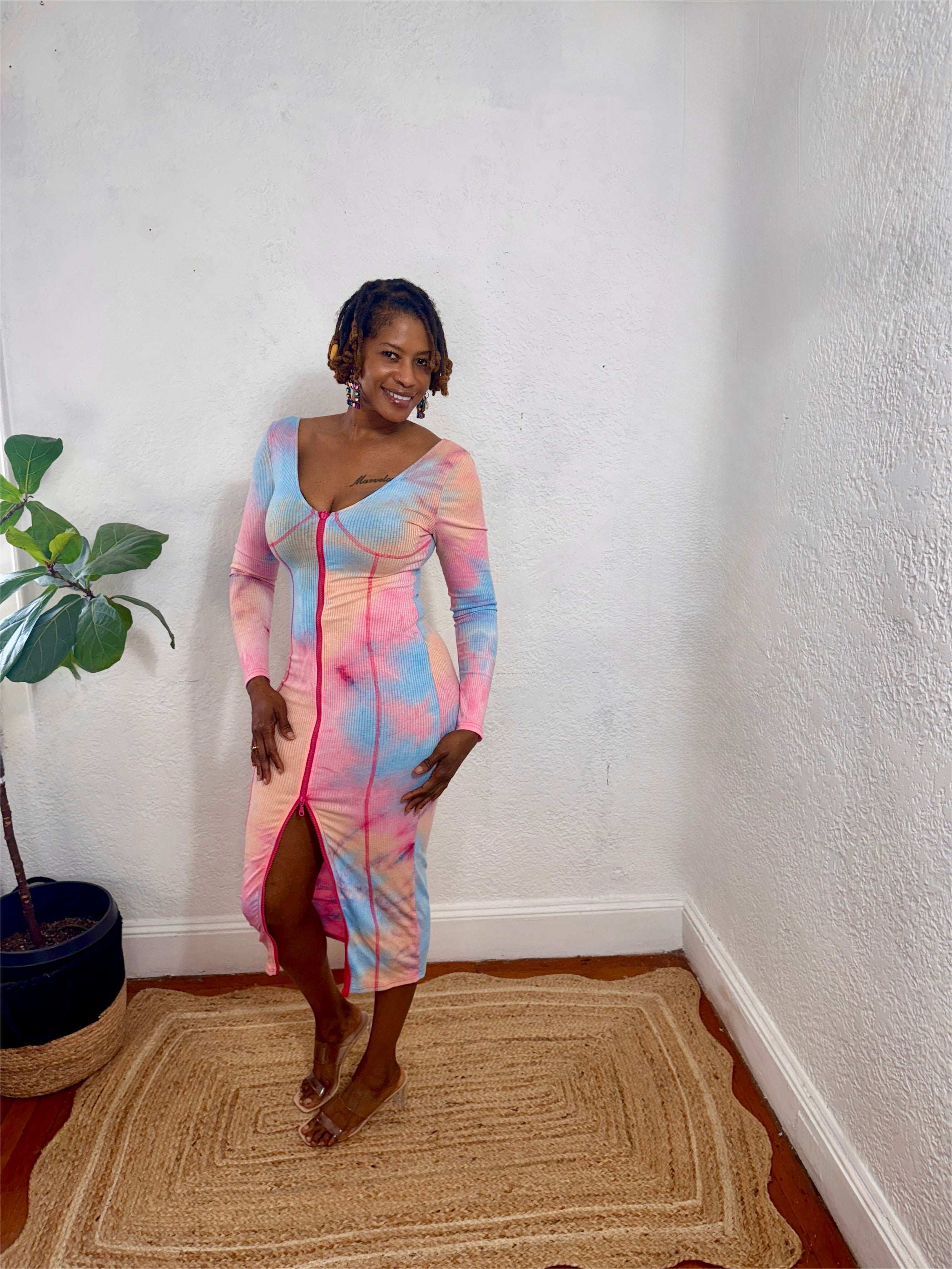 Woman wearing the Zipline Curve Dress in coral, blush, and blue tie-dye.