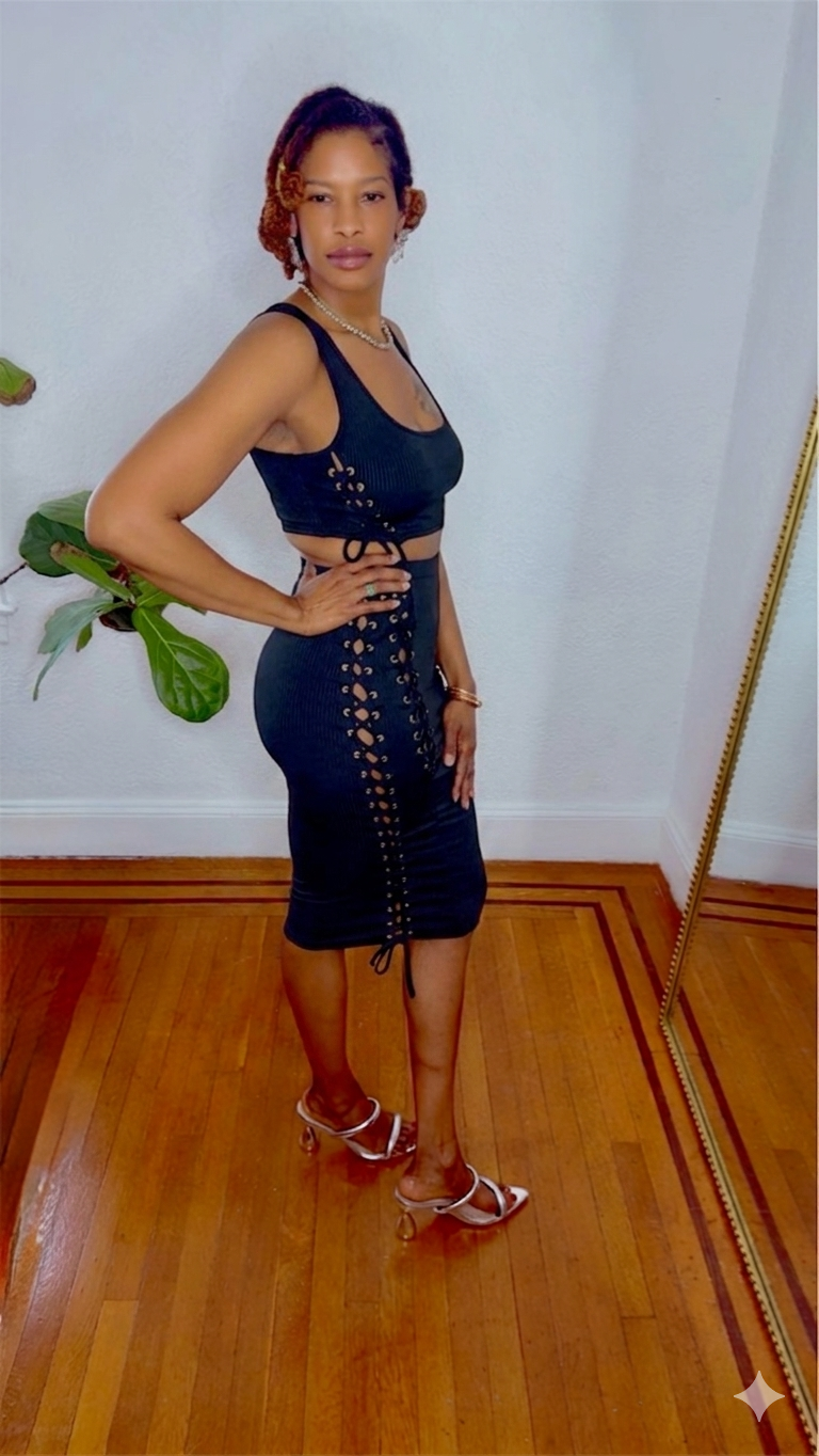 Black Swan Lace Dress in black-swan-lace-dress-side-view showing lace-up side detailing and body-hugging midi length from MonologueClosets