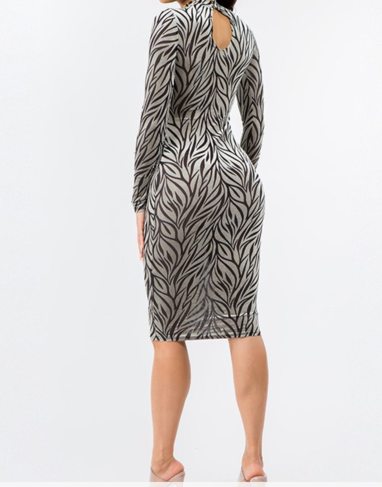 Back view of zebra-print mock-neck dress highlighting midi length.